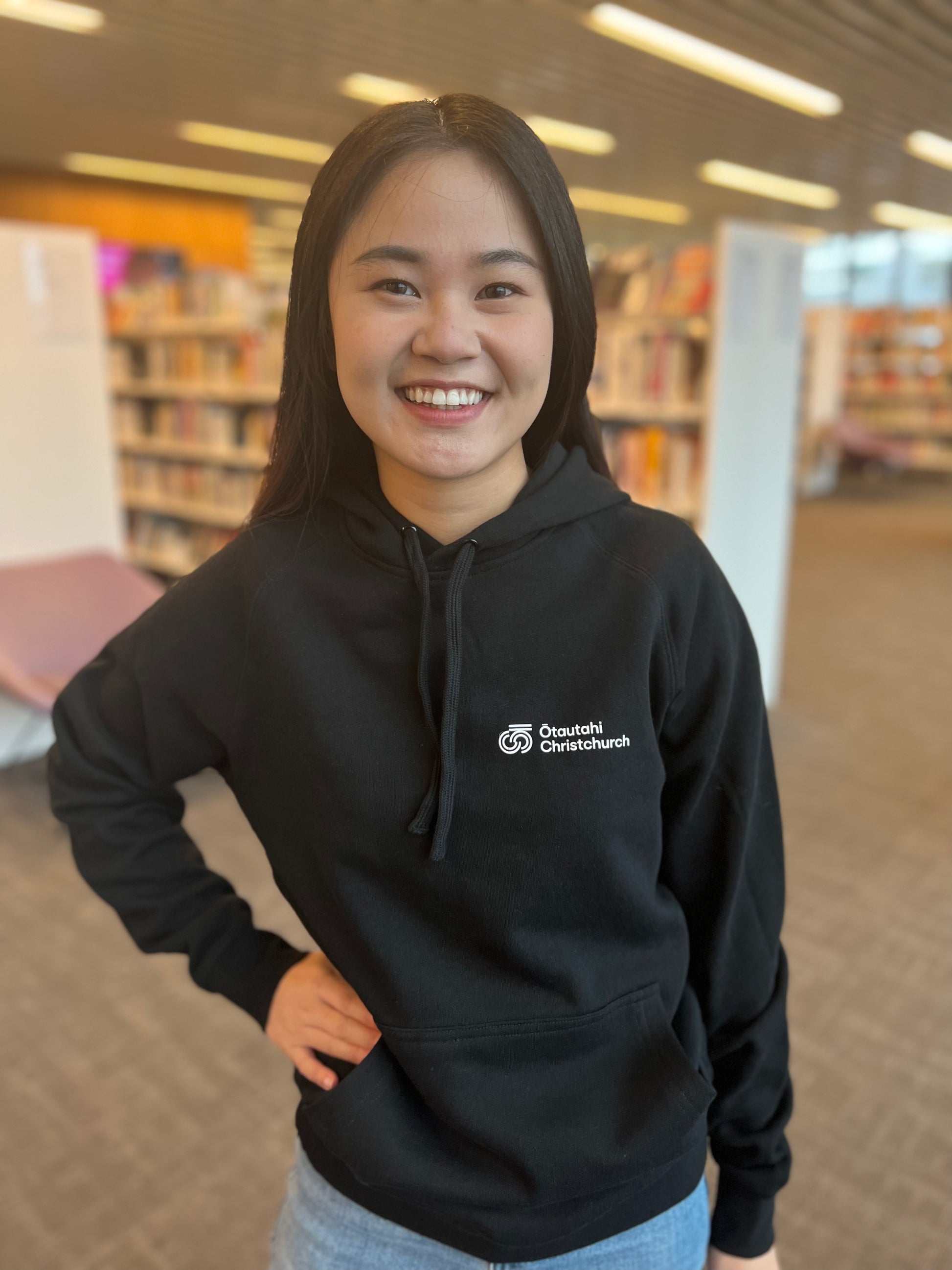 Women wearing black OC hoodie with logo on front